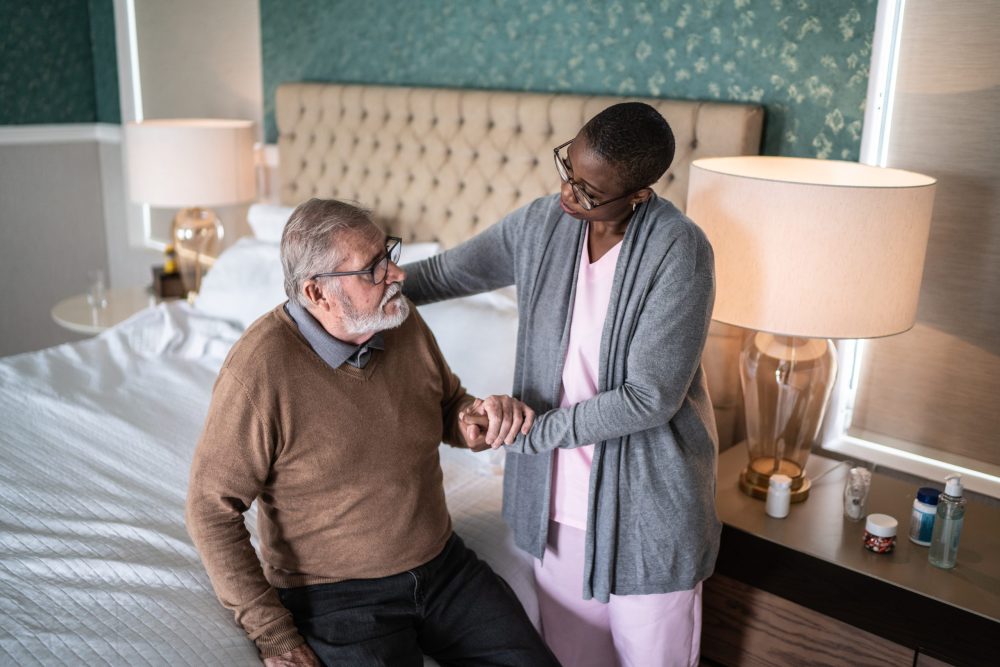 Home caregiver helping elderly patient