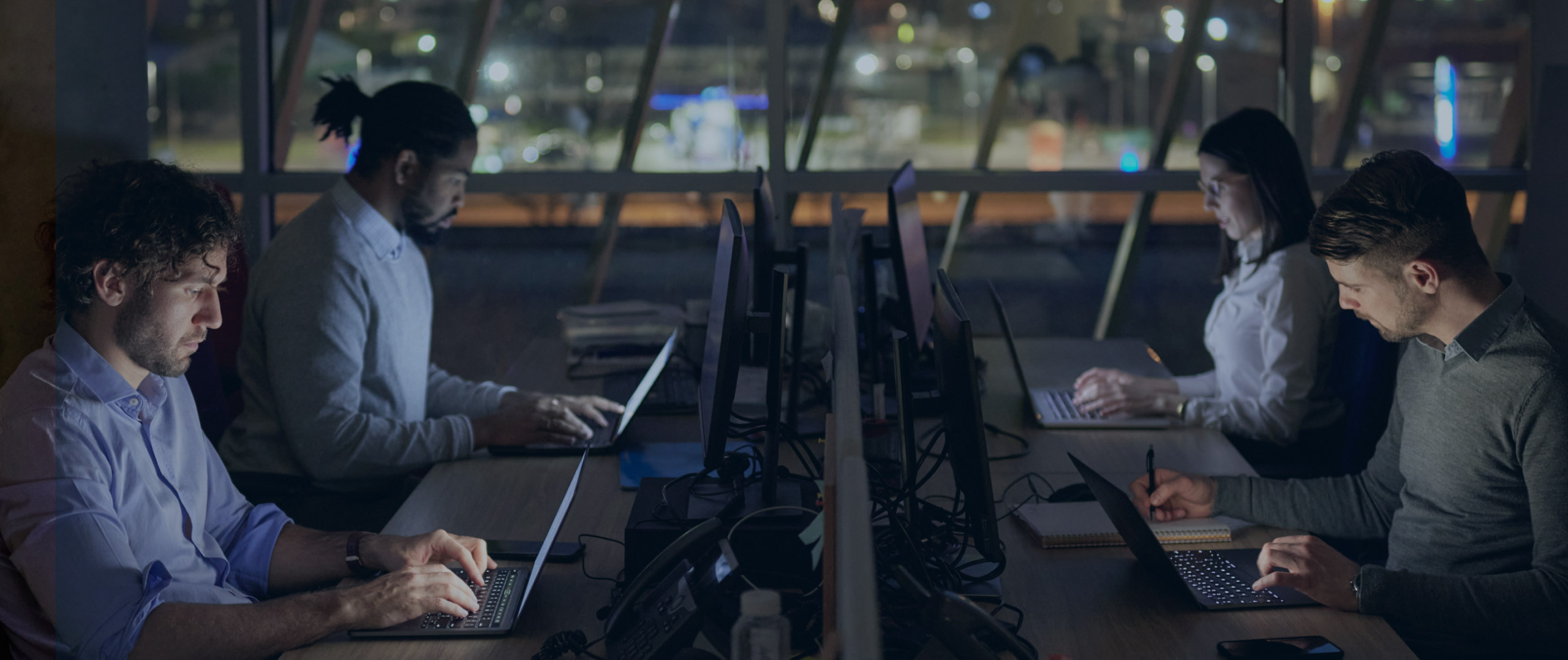 Group of people working at work stations.